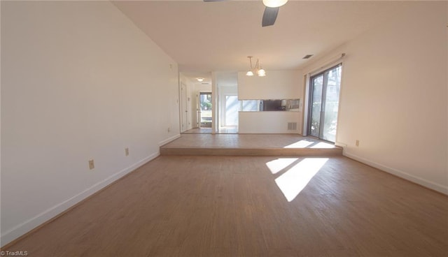 spare room with hardwood / wood-style floors, a wealth of natural light, and ceiling fan