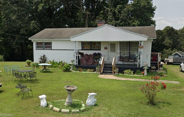 single story home with a front yard and covered porch