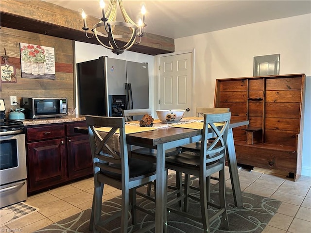 dining space featuring a chandelier and light tile patterned floors