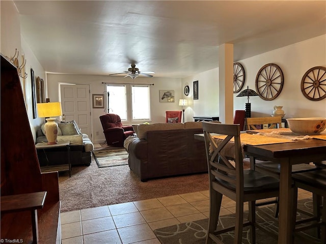 dining room featuring light tile patterned floors, light colored carpet, and ceiling fan