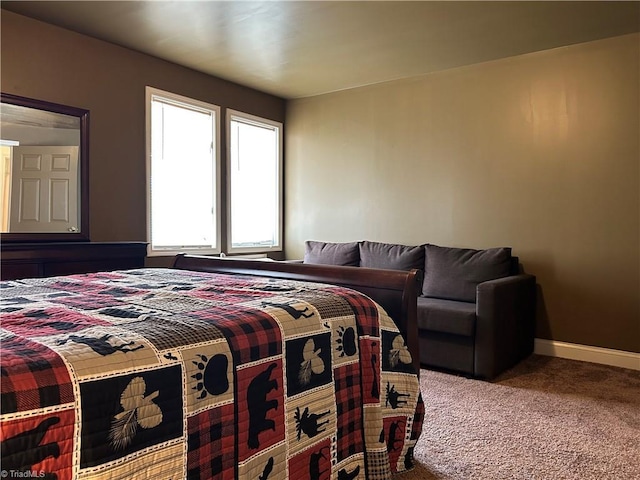 carpeted bedroom featuring baseboards