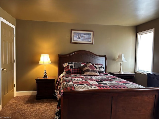 bedroom featuring carpet floors and baseboards