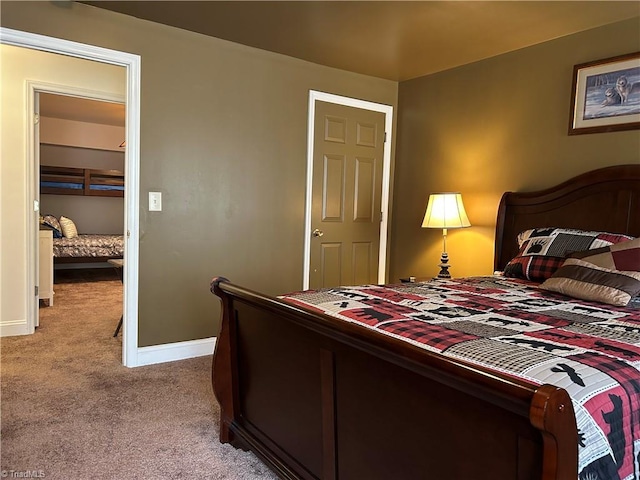 bedroom featuring carpet floors and baseboards