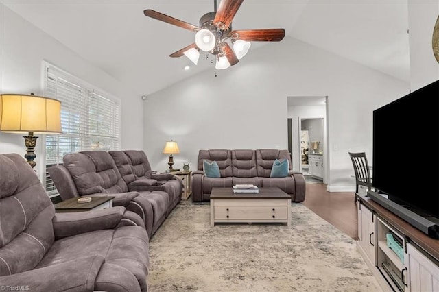 living room featuring a ceiling fan, high vaulted ceiling, and wood finished floors