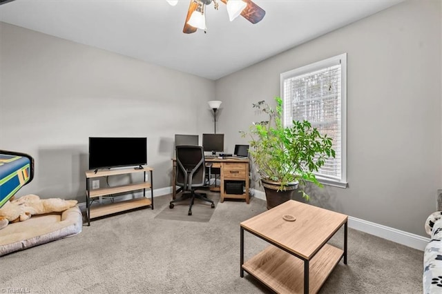 office space featuring carpet floors, baseboards, and a ceiling fan