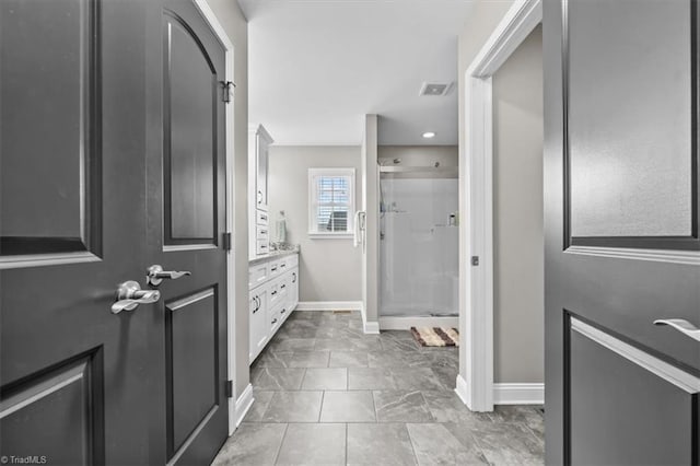 full bathroom featuring baseboards, visible vents, a shower stall, and vanity