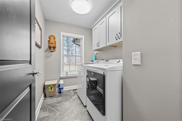 laundry area with baseboards, marble finish floor, cabinet space, and washer and dryer