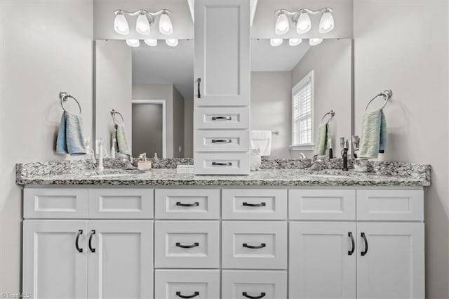 bathroom featuring double vanity and a sink