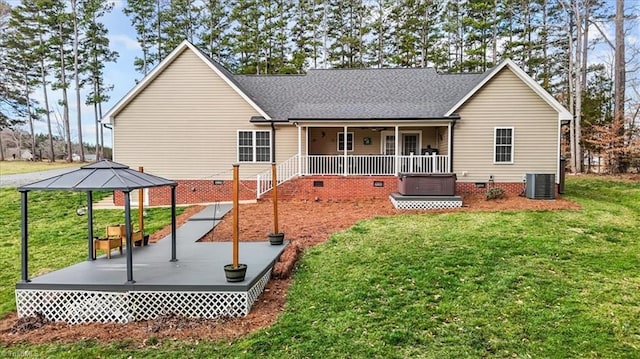 rear view of property featuring central air condition unit, a shingled roof, a gazebo, crawl space, and a lawn