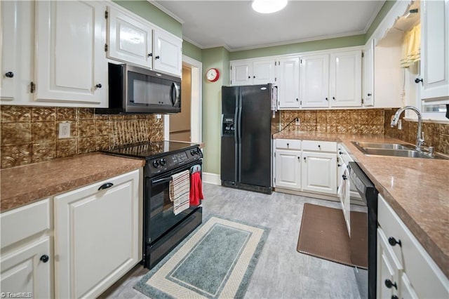 kitchen with black appliances, backsplash, a sink, and white cabinets