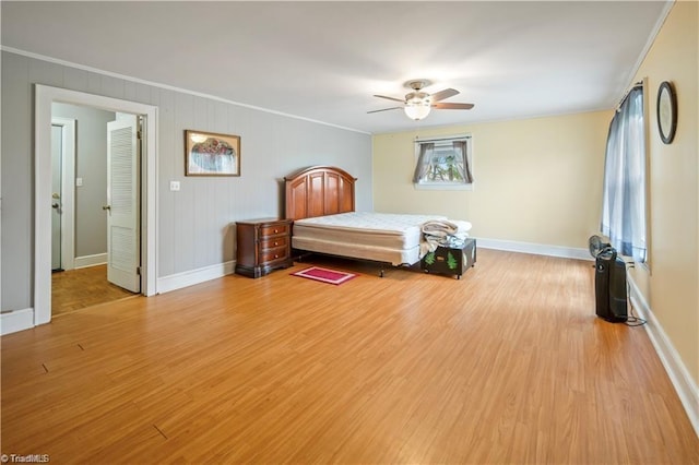 unfurnished bedroom featuring ornamental molding, light wood-type flooring, and baseboards