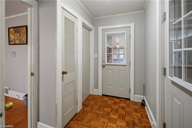 entryway with ornamental molding, visible vents, and baseboards