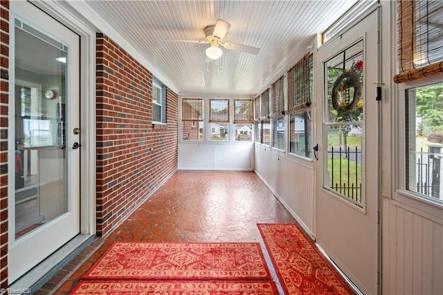 sunroom with a healthy amount of sunlight and a ceiling fan