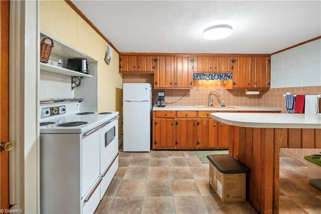 kitchen featuring white appliances, a sink, light countertops, brown cabinets, and decorative backsplash