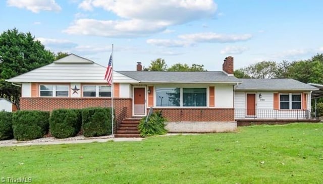 single story home with brick siding and a front yard