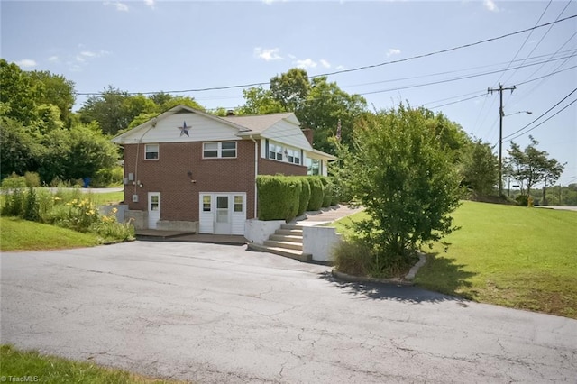 1304 Forrest Dr, Mount Airy, NC 27030 - view of property exterior featuring brick siding, asphalt driveway, and a lawn