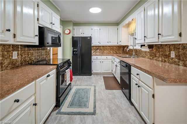 kitchen with tasteful backsplash, light wood-style floors, white cabinets, a sink, and black appliances