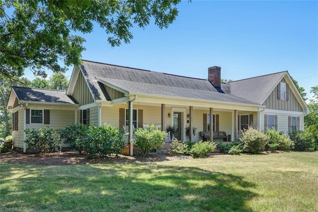 view of front of house with a porch and a front lawn