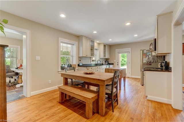 dining area featuring sink and light hardwood / wood-style floors