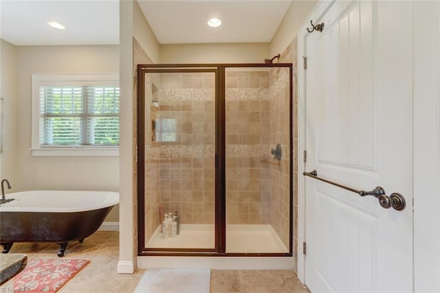 bathroom featuring independent shower and bath and tile patterned flooring