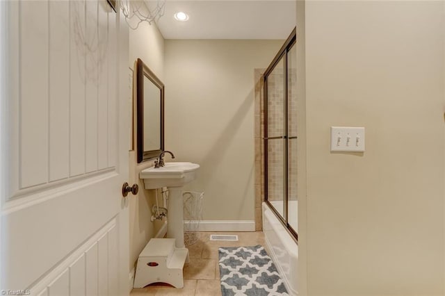 bathroom featuring enclosed tub / shower combo and tile patterned floors