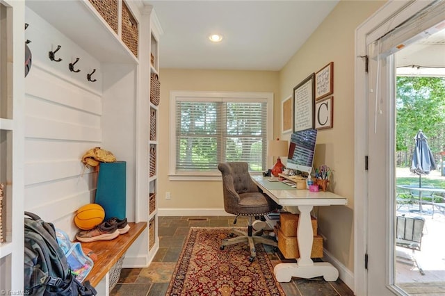 office space with dark tile patterned flooring and plenty of natural light