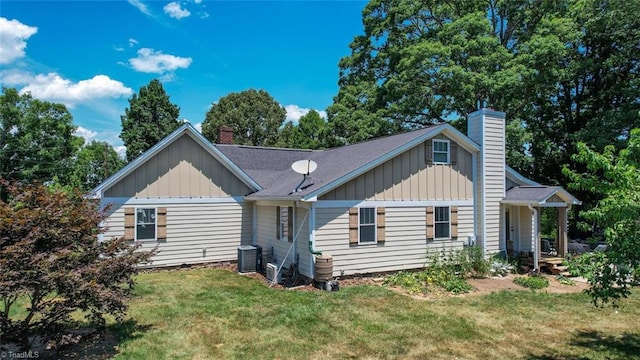 view of front of property featuring central air condition unit and a front yard