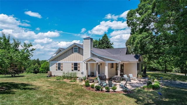 back of property with a patio and a yard