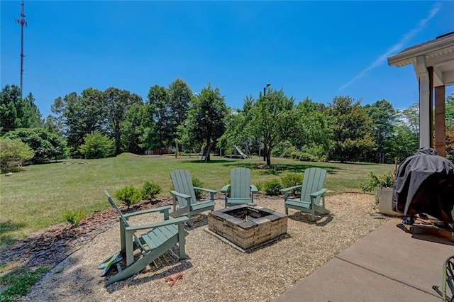 view of yard featuring a patio and an outdoor fire pit