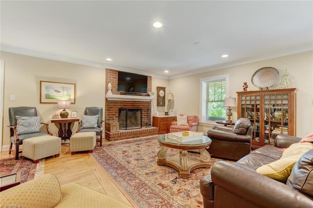 living room featuring brick wall, ornamental molding, a fireplace, and hardwood / wood-style flooring