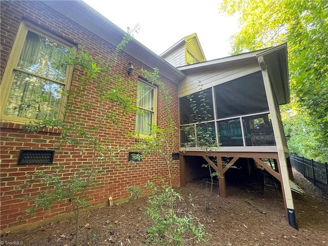 view of property exterior with a sunroom