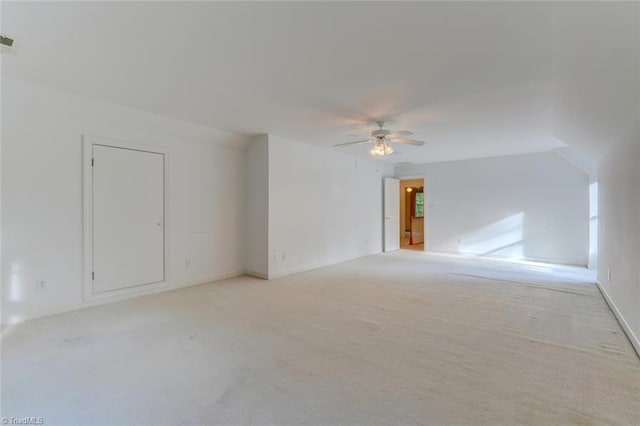 spare room with ceiling fan and light carpet