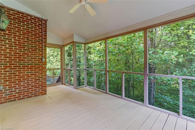 unfurnished sunroom featuring lofted ceiling and ceiling fan