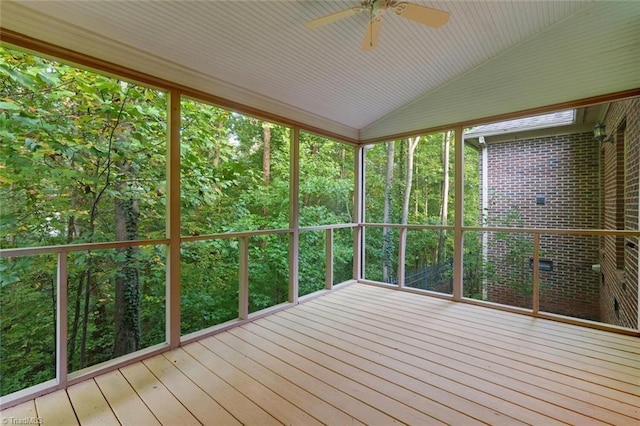 unfurnished sunroom featuring ceiling fan and vaulted ceiling