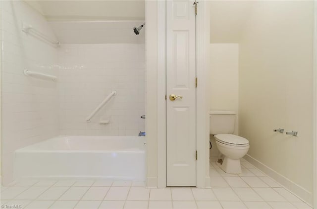 bathroom featuring tiled shower / bath, tile patterned flooring, and toilet