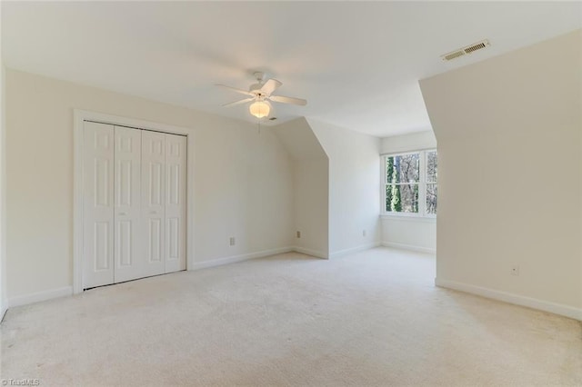 bonus room featuring ceiling fan, light colored carpet, and lofted ceiling