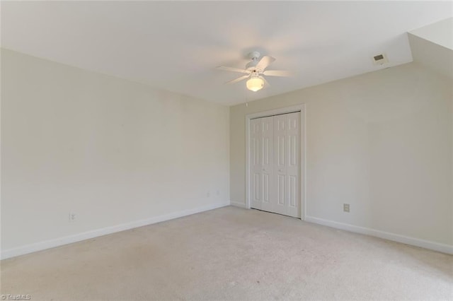 carpeted spare room with ceiling fan