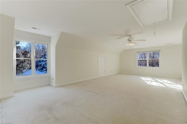 interior space featuring ceiling fan, vaulted ceiling, and light colored carpet