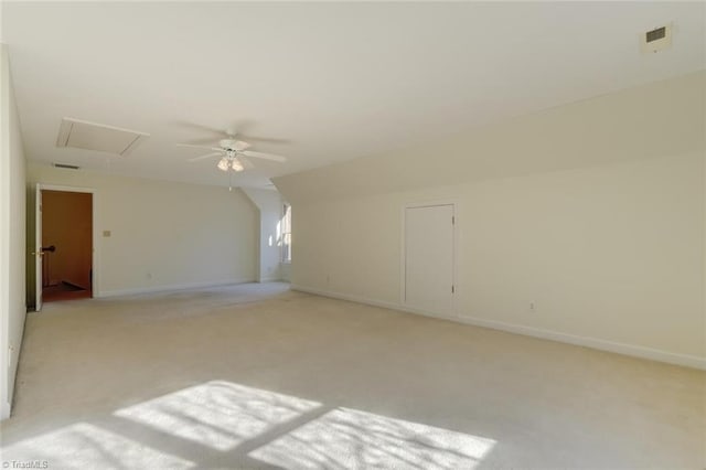 additional living space with ceiling fan and light carpet