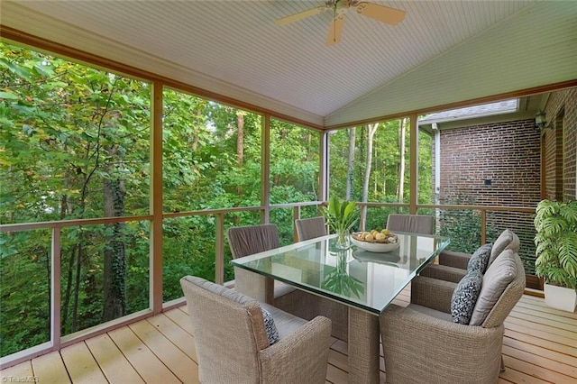 sunroom / solarium featuring lofted ceiling and ceiling fan