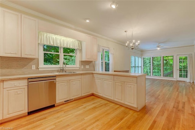 kitchen featuring kitchen peninsula, sink, decorative light fixtures, stainless steel dishwasher, and ceiling fan with notable chandelier