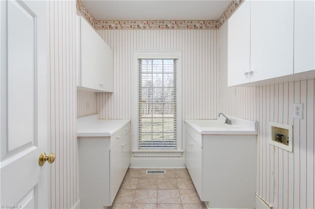 laundry area with visible vents, washer hookup, cabinet space, wallpapered walls, and light tile patterned floors