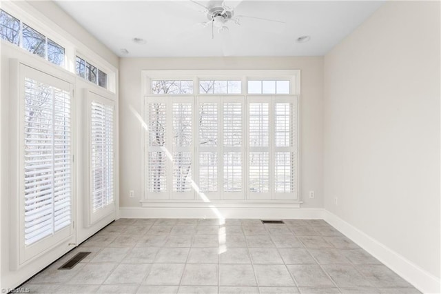 spare room featuring visible vents, baseboards, and a healthy amount of sunlight