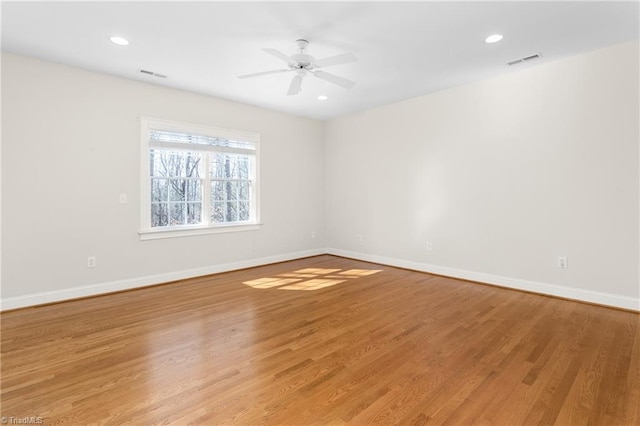 unfurnished room with light wood-type flooring, visible vents, a ceiling fan, recessed lighting, and baseboards