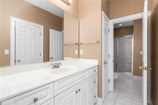 full bath with tile patterned flooring, a stall shower, toilet, and vanity