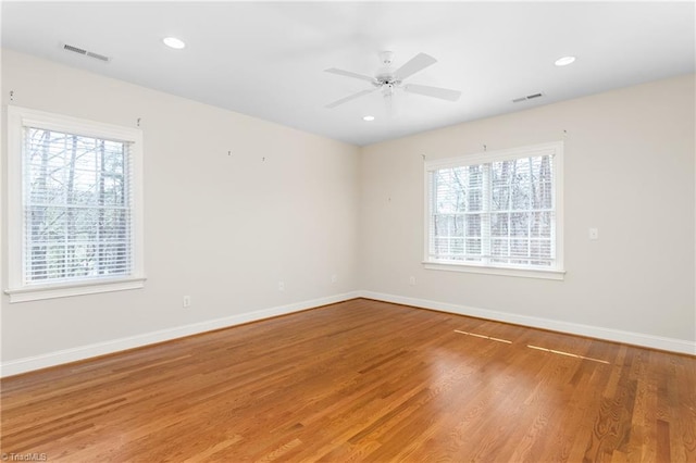 unfurnished room with recessed lighting, visible vents, baseboards, and wood finished floors