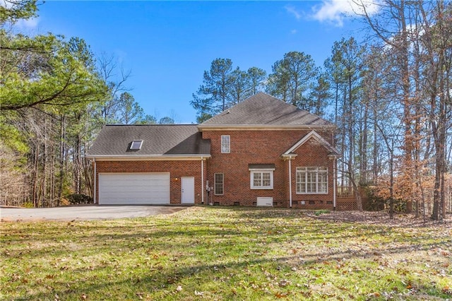 view of front of house with driveway, brick siding, an attached garage, and a front lawn