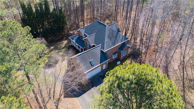 birds eye view of property with a wooded view