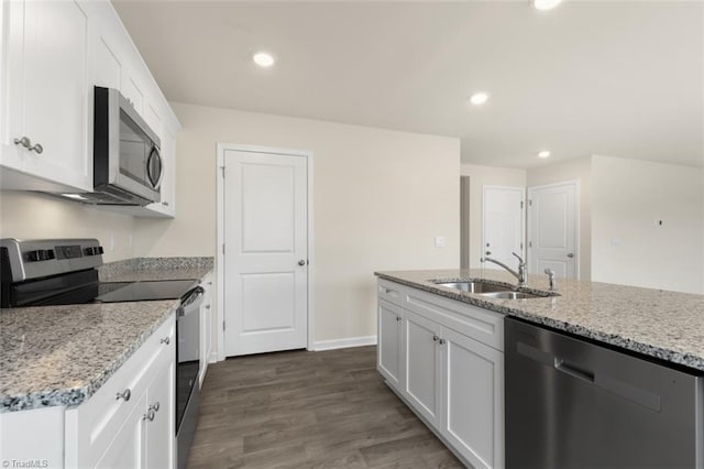 kitchen featuring dark hardwood / wood-style flooring, light stone counters, sink, appliances with stainless steel finishes, and white cabinets