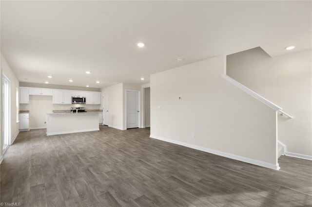 unfurnished living room featuring dark wood-type flooring